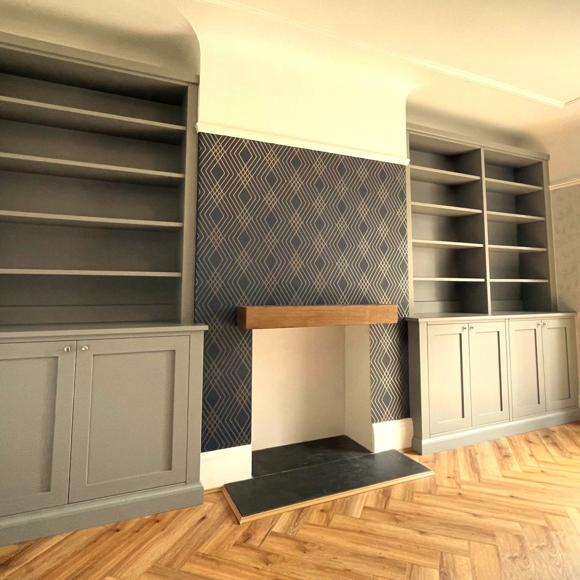grey double alcove cabinets in living room with wooden floor and fireplace